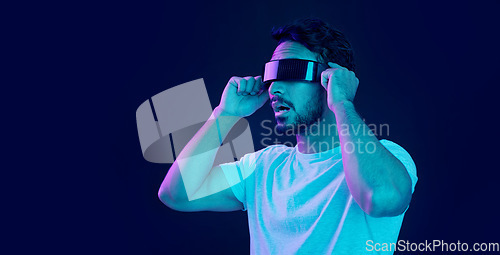 Image of Man with vr headset, gamer and digital transformation for metaverse experience in technology. Person streaming augmented reality simulation, futuristic gaming and studio with dark background
