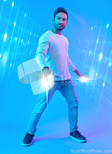 Image of Hologram, metaverse and portrait of a man in a studio with a cyber, digital or scifi overlay for gaming. Virtual reality, futuristic and male gamer with a 3d fantasy experience by a blue background.