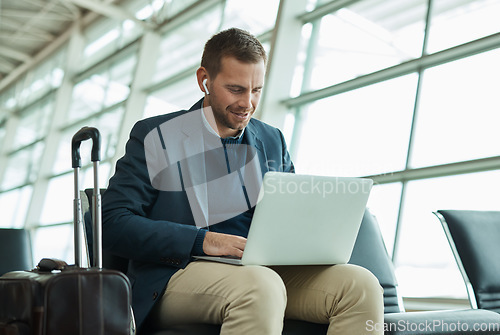 Image of Airport, business man and laptop for music during travel or working in lobby streaming internet. Entrepreneur person with luggage in building for video call while typing email, search or news