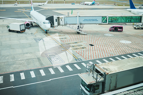Image of Stationary airplane at airport, aircraft transport on tarmac and runway for international passenger travel driveway. Plane on ground, outdoor flight terminal and cargo carrier on aeroplane runway