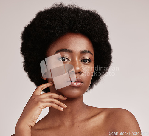 Image of Portrait, skin or natural and a model black woman in studio on a gray background with afro hair. Skincare, cosmetics and beauty with an attractive young female posing indoor for health or wellness