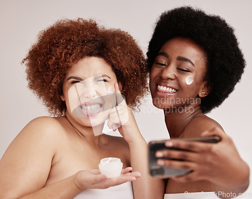 Image of Skincare, silly and cream with friends and selfie for product, facial and spa. Meme, phone and social media with black women and funny face with lotion for health, makeup and wellness in studio