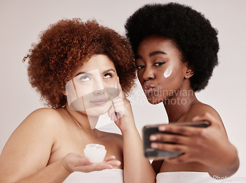 Image of Skincare, funny and facial with friends and selfie for product, beauty and spa. Comic, phone and social media with black women and silly face photo with cream for health, makeup or wellness in studio