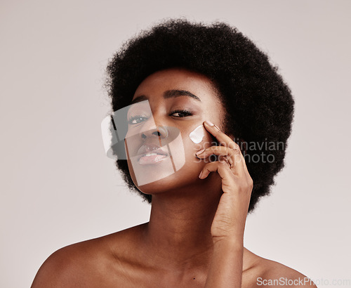 Image of Beauty, portrait of black woman with cream on face and afro, advertising luxury skincare with collagen product promotion. Dermatology, cosmetics and spa facial for model isolated on studio background