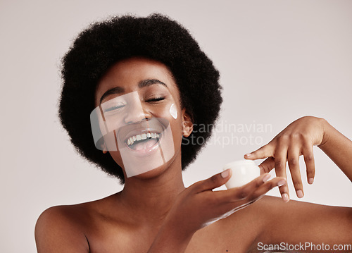 Image of Skincare, black woman with finger in cream and smile on face, afro and advertising luxury skin product promotion. Dermatology, cosmetics and facial beauty, happy model isolated on studio background.