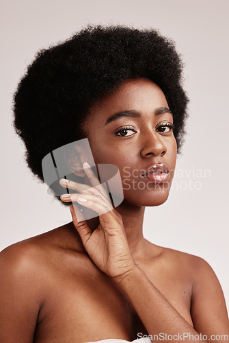 Image of Portrait, natural or skincare and a model black woman in studio on a gray background with afro hair. Skin, cosmetics and beauty with an attractive young female posing indoor for health or wellness