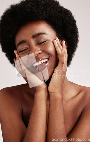 Image of Beauty, black woman and smile of a young African person face with hands happy about facial. Wellness, cosmetics and model relax in a isolated studio doing dermatology, detox and spa self care