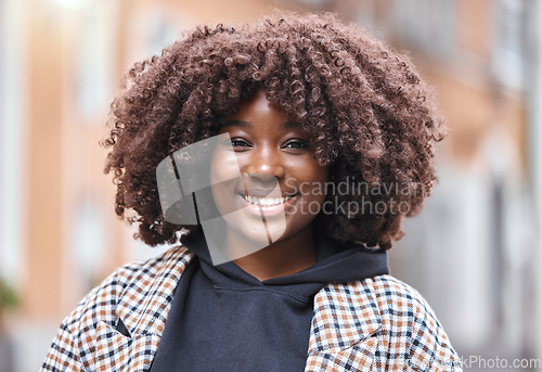 Image of Happy, smile and portrait of a black woman in the city with optimistic, good and positive mindset. Happiness, excited and face of African female with an afro standing in town while on holiday or trip