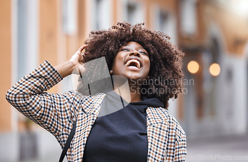 Image of Black woman, laughing and afro hair in city fun, goofy or silly travel in urban New York or holiday location. Smile, happy or comic student in fashion, trendy or cool clothes with natural hairstyle