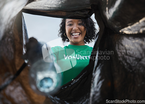 Image of Recycle, smile and woman with view in bag, sustainability and cleaning plastic pollution for earth day and community service. Saving the environment, charity and people putting trash in garbage.