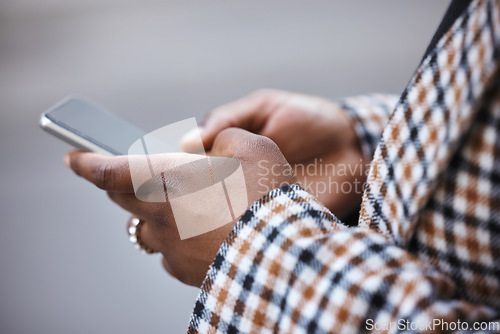 Image of Closeup, black hands and smartphone for typing, outdoor and connection for social media, chatting and online reading. African woman, zoom and female with cellphone, city and communication with device