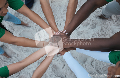 Image of Teamwork, support and volunteer with hands of people from top at beach for sustainability, environment or climate change. Community, earth day or diversity with friends for recycling, charity or goal