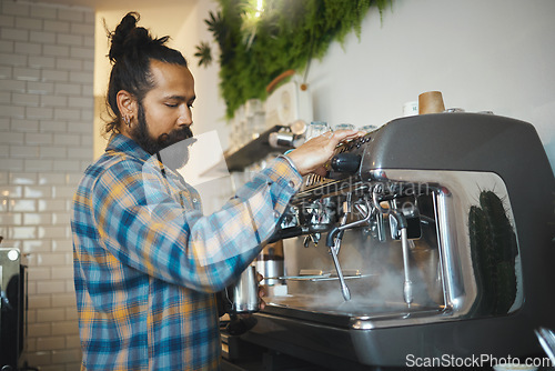 Image of Man in cafe, barista working machine and create drink with focus and small business, workflow and process. Espresso, latte or cappuccino production, busy server in coffee shop with steam for cleaning