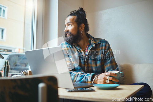 Image of Laptop, coffee and man in a cafe working on a creative freelance project or small business strategy. Cafeteria, computer and male freelancer doing remote work while drinking a latte in a restaurant.