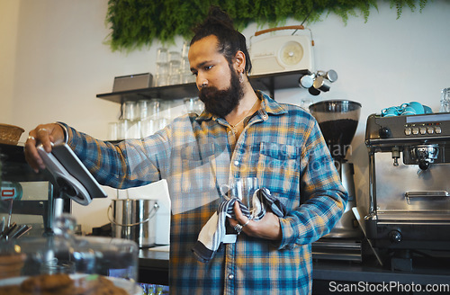 Image of Coffee, tablet and barista reading orders, checklist or inventory online while working at a cafe. Service, morning and man with technology ordering supplies, product and connection with supplier