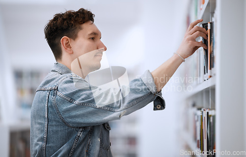 Image of Man, books and library bookshelf for education, learning and knowledge by reading and studying. Student person in college room with choice or decision to study information for scholarship research