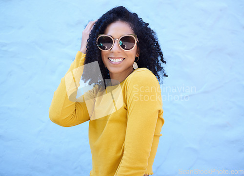 Image of Fashion sunglasses, portrait and black woman on blue background, excited face and trendy cool clothes. Summer, shades and happy girl model smile with vision, yellow color style and urban wall mockup