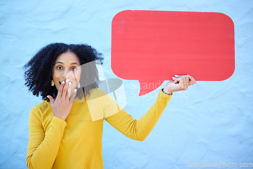 Image of Portrait, wow and black woman with speech bubble in studio for advertising, mockup and social media on blue background. Face, omg and girl with billboard or poster on news, discount or shock sale