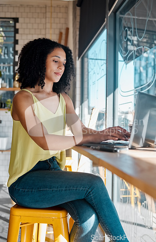 Image of Black woman, laptop or typing in coffee shop, cafe or restaurant for internet blog, research or startup planning. Thinking, student or freelance creative on remote work technology for small business