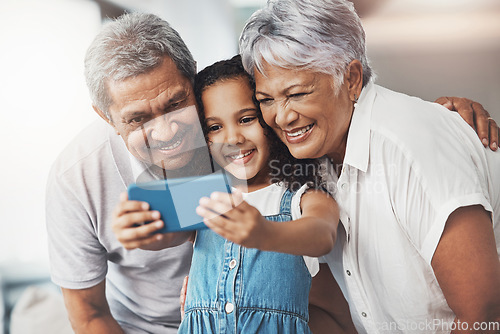 Image of Love, happy and girl taking selfie with her grandparents for social media in modern family home. Happiness, smile and excited child taking picture with grandmother and grandfather at house in Mexico.
