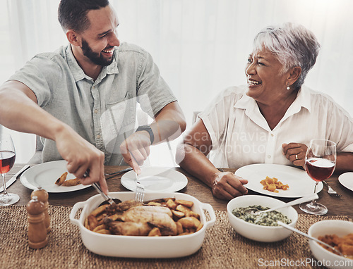 Image of Love, mother and adult son cut chicken, event and conversation with happiness, family and loving together. Happy, mama and male child with food, smile or enjoy party for quality time or weekend break