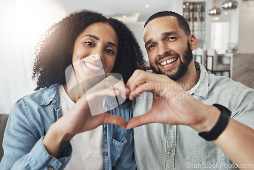 Image of Love, heart hand sign and portrait couple enjoy quality time together, bonding or relax on home living room sofa. Happiness, emoji gesture or happy marriage people, man or woman in good health