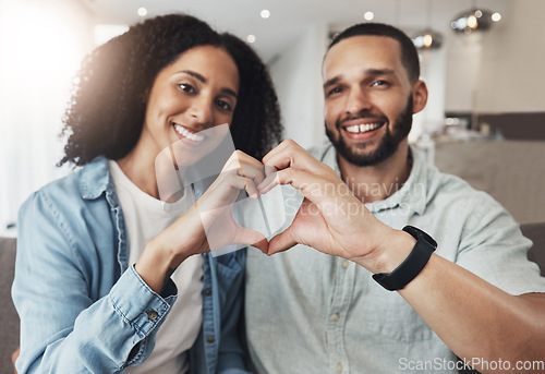 Image of Love portrait, heart sign or happy couple enjoy quality time together, bonding or relax on home living room sofa. Happiness, emoji gesture and marriage people, man or woman smile in good health