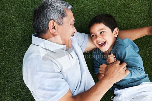 Image of Grandfather, child and laughing on grass having fun with love and grandparent care. Laugh, happy kid from above and senior man together outdoor on summer vacation with family and bonding in nature