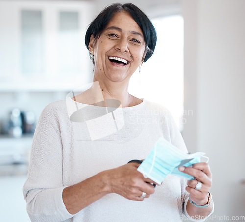 Image of Senior woman, portrait and covid face mask with a scissor in hands for cutting while happy about freedom. Face of old person in house with smile for change, vaccine and corona recovery in retirement