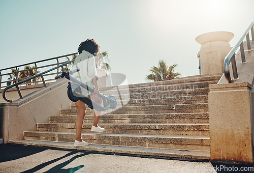 Image of Walking, scooter and a black woman in the city using eco friendly transport to commute from the back. Street, travel and zero emission with a female aware of her carbon footprint on the environment