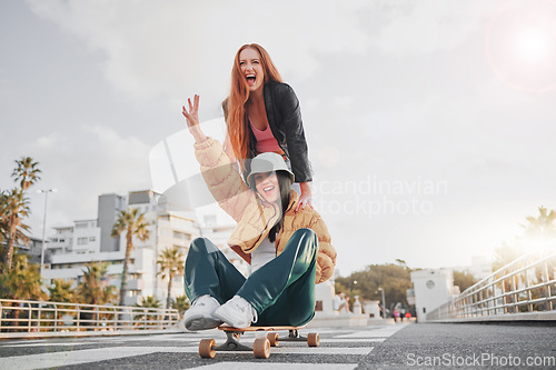 Image of Fun, energy and portrait of friends on a skateboard for the weekend, bonding and playing in the city. Excited, silly and crazy women skateboarding for funny activity, happiness and playful in Sweden