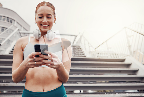 Image of City, workout and woman with smartphone, smile for communication, typing and headphones after exercise. Health, training and runner on 5g phone, fitness app to connect or network in sports.