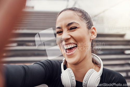 Image of Woman, face and selfie with headphones and exercise in city, happy in Brazil, laughter and fitness outdoor. Runner, cardio and happiness in picture, health and wellness with active lifestyle