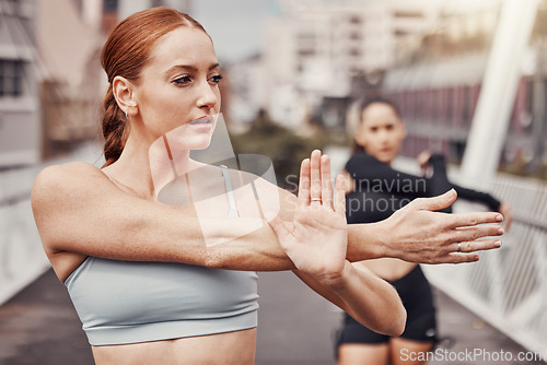 Image of Friends, woman and personal trainer in city stretching for outdoor workout on bridge for health and wellness. Sports, motivation and mindset, urban training and people stretch together for exercise.