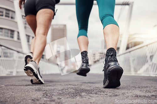 Image of Fitness, city or legs running in training, workout or cardio exercise on New York bridge for a marathon. Zoom, runners or friends athletes with sports motivation, mindset or resilience for goals