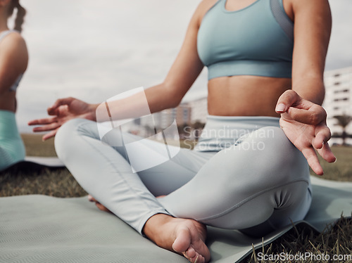 Image of Fitness, hands and woman in yoga meditation for spiritual wellness, mind and body on mat in the city. Hand of calm female yogi in relax lotus pose for healthy wellbeing, zen or exercise in Cape Town