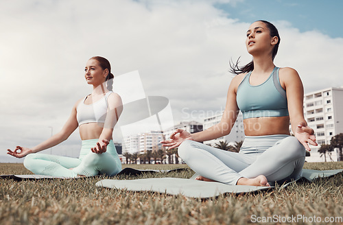 Image of Girl friends, yoga and lotus meditation on grass at urban park for peace, body wellness or focus outdoor. Gen z group, woman or mindfulness exercise on lawn by buildings, city or health to relax mind