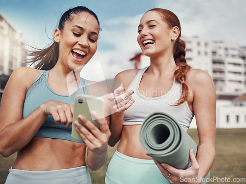 Image of Yoga, fitness and phone with woman friends laughing at a meme in the park together during exercise. Pilates, social media and training with a female and friend joking outside on a field for a workout