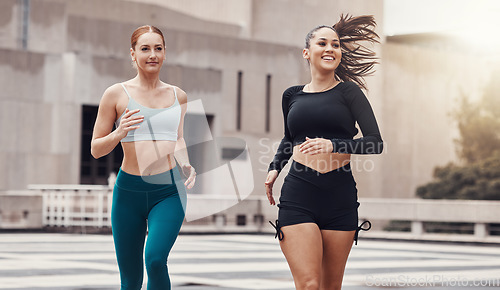 Image of Women, friends running and together in city for workout, wellness and healthy strong body for teamwork in morning. Woman training group, exercise or runner team in metro with support, smile and happy