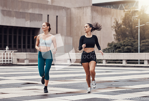 Image of Fitness, city and friends running together for wellness, energy or outdoor exercise. Sports, healthy women and runner athletes training for cardio workout in urban town with freedom, power and action