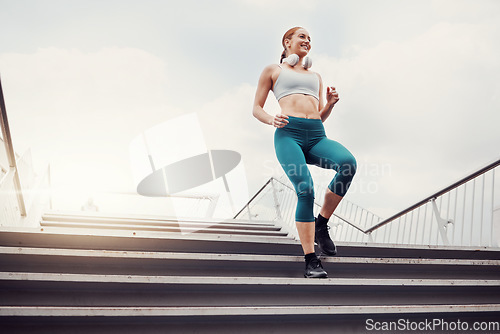 Image of Fitness, woman and runner on stairs in the city for cardio exercise, training or healthy workout. Active female running and exercising on staircase for intense run or weight loss in an urban town