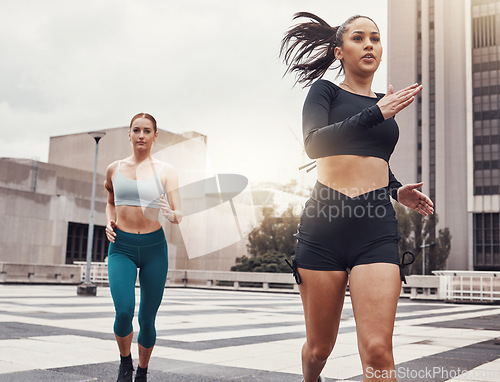 Image of Women, running in city and fitness, runner outdoor for cardio and exercise friends race in Cape Town for active lifestyle. Sports, health and body training, run on urban rooftop with healthy people