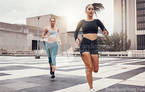 Image of Women, running and fitness in city with cardio, exercise friends and active lifestyle together in Cape Town. Sports, health and body training, runner run race on urban rooftop with healthy people