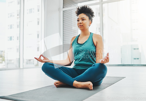 Image of Yoga, black woman and meditation with lotus exercise for fitness, peace and wellness. Young person in health studio for holistic workout, mental health and body balance with zen energy to relax