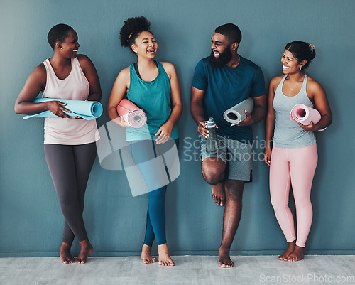 Image of Yoga, fitness friends and wall of pilates class in a gym with a exercise and training break. Talking, wellness black people and communication of group on a floor ready for zen, balance and relax