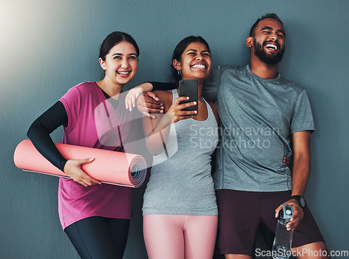 Image of Fitness friends laugh with phone and diversity, funny meme on social media and exercise together with yoga mat. Comedy online, workout group in gym with healthy lifestyle, wellness and happy people