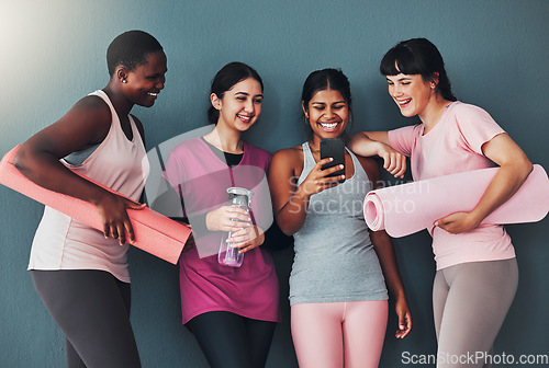 Image of Fitness, friends and funny meme on smartphone, online comedy while at gym with women at yoga and exercise. Workout together, diversity and social media with connection and health on studio background