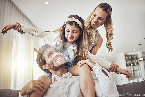 Image of Family, bonding and airplane game in living room, house or relax home in freedom activity, kids energy or fun playing. Smile, happy and flying child on father shoulders in fantasy support with mother