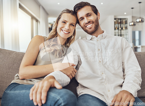 Image of Couple. portrait and home of young people together on a living room couch with love and care. Happiness, smile and hug of a man and woman on a sofa feeling relax in a house lounge with marriage