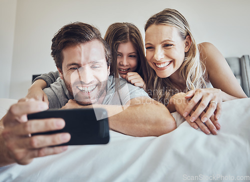 Image of Portrait, relax or parents take a selfie with a girl as a happy family in house bedroom bonding in Berlin. Mother, father or child relaxing together enjoying quality time or taking pictures at home